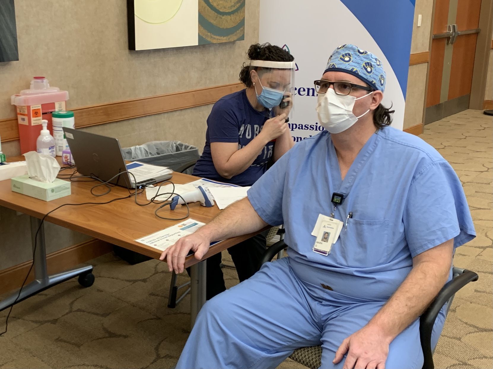 Mark Gustafson, an RT with Ascension Franklin, gets vaccinated Wednesday